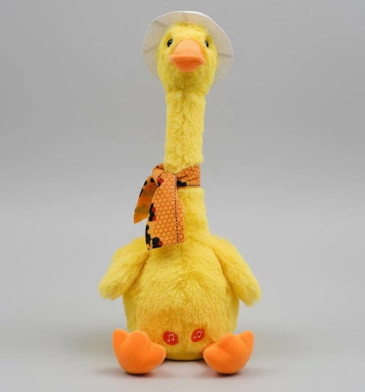 Yellow plush duck with a white hat and orange scarf on a gray background
